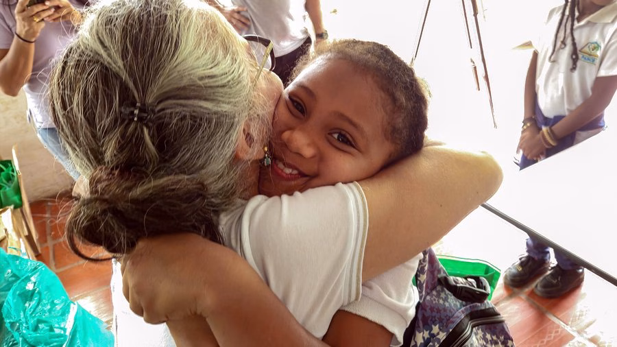 Abrazo durante entrega comunitaria